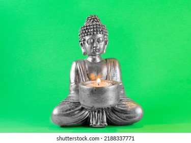 buddha statue with lit candle. green screen - Powered by Shutterstock