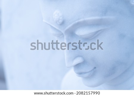 Buddha statue made of beautiful white limestone to be worshiped according to the faith.