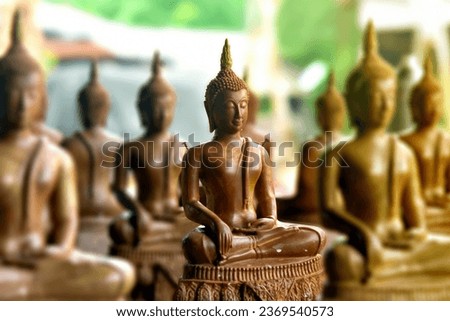 Buddha statue made from bee wax,Hobbies and creativity, craft. Faith and religion,Candle figures of saints from beeswax made by hands 