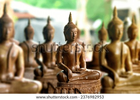 Buddha statue made from bee wax,Hobbies and creativity, craft. Faith and religion,Candle figures of saints from beeswax made by hands 