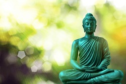 Buddha Statue Meditating On Natural Blurred Bokeh Background.