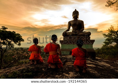 Buddha statue and Novice at sunset in Saraburi, Thailand
