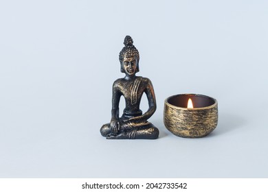 Buddha statue on altar with burning candle. Meditation, buddhism and enlightenment concept