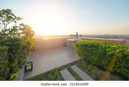 A buddha statue on sky garden on private rooftop of condominium or hotel, high rise architecture building with tree, grass field, and blue sky. - Shutterstock ID 2114515499