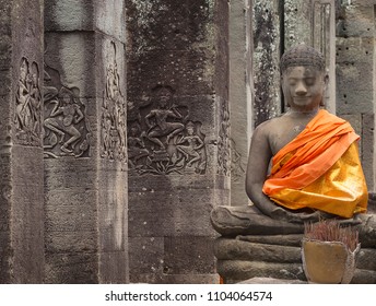 Buddha Statue With Orange Tunic In The Temples Of Angkor