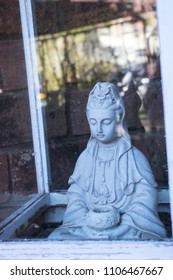 Buddha Statue Sitting In A Glass Box