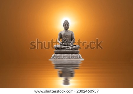 Buddha statue sitting and reflection on sunset background.