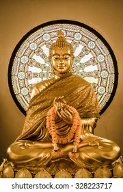 Buddha statue and Wheel of life background made from mosaic