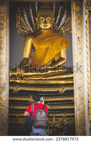 Buddha Statue with worshippers in Bangkok, Thailand.