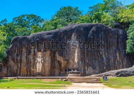 Buddha statues carved into stone at buduruwagala ancient site at Sri Lanka.