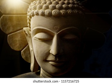 Buddha's Head Statue Carved From Sandstone By Handmade Artisan
Who Believe Strongly And Faith In Buddhism With Soft Light Background.
