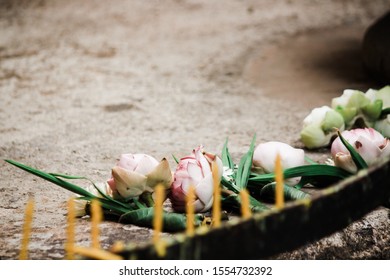 Buddhism use Buddha oblation (Lotus flower,incense sticks and candle) to worship Buddha statue.candles and incense sticks in hands for praying respect to the buddha statue - Powered by Shutterstock