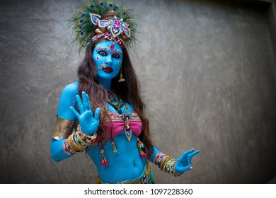 Buddhist deity: Woman with face & body paint.