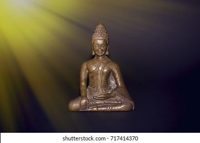 Buddhist Meditation. Traditional Bronze Buddha Meditating In Rays Of Divine Light. Zen Buddhism And Spiritual Enlightenment Or Awakening. New Age Image With Copy Space.