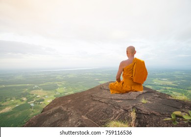 Buddhist monk in meditation at beautiful nature on high mountain