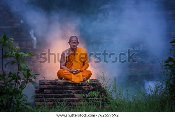 Buddhist Monk Meditation. Wat Choeng\
Tha is an ancient temple built in the Ayutthaya\
period.
