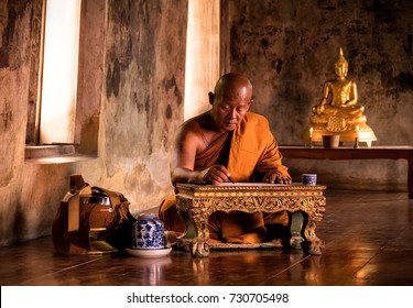 Buddhist monk reading book in the ancient church