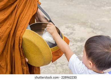 Buddhist monks are given food offering from people for End of Buddhist Lent Day - Powered by Shutterstock