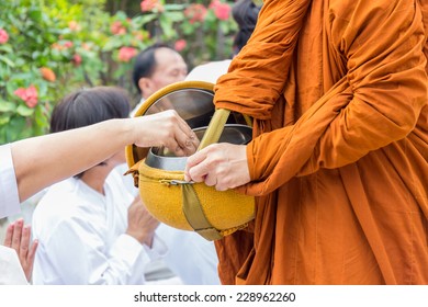Buddhist monks are given food offering from people for End of Buddhist Lent Day - Powered by Shutterstock