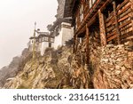 Buddhist nunnery in the mountains during snowfall, Kila nunnery, between Paro and Haa, Himalayan region, Bhutan