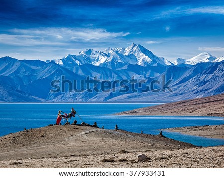 Buddhist prayer flags lungta at Himalayan lake Tso Moriri in the morning. Korzok, Ladakh, Jammu and Kashmir, India