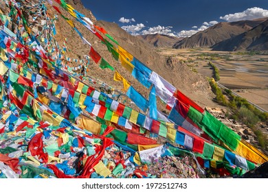 Buddhist prayer flags near the Yungbulakang Palace or Yumbu Lakhang, high on the Tibetan Plateau in the Himalayas in the Tibet Autonomous Region of China.
