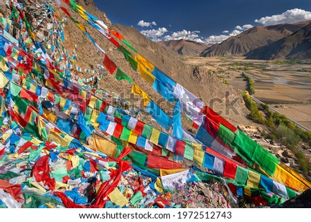 Buddhist prayer flags near the Yungbulakang Palace or Yumbu Lakhang, high on the Tibetan Plateau in the Himalayas in the Tibet Autonomous Region of China.