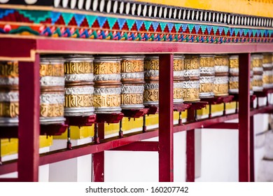 Buddhist prayer wheels in Tibetan monastery with written mantra. India, Himalaya, Ladakh 