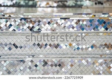 Buddhist Temple pillars and bas of pillars are decorated with Mosaic mirror. Traditional Thai temple pillar decorated with beautiful mosaic pattern inside the Buddhist temple.