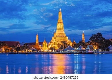 Buddhist temple Wat Arun (Wat Arun Ratchawararam Ratchawaramahawihan - Temple of Dawn) famous tourist landmark illuminated in the evening. Bangkok, Thailand - Powered by Shutterstock