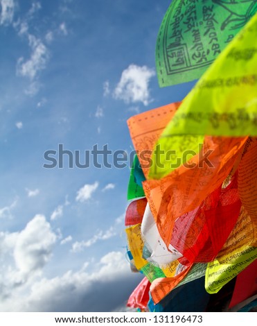 Buddhist tibetan prayer flags flying with blue sky