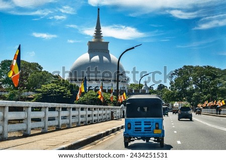 Buddhistic temple Kalutara Bodhiya (Ihala Maluwa) from road and bridge. Sri Lanka.