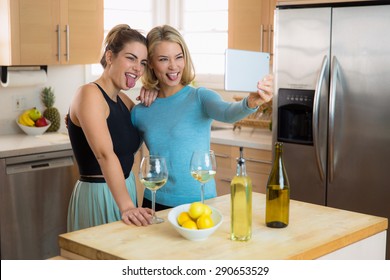 Buddies Taking Selfie On A Tablet Making Goofy Funny Faces Laughing And Being Young And Silly