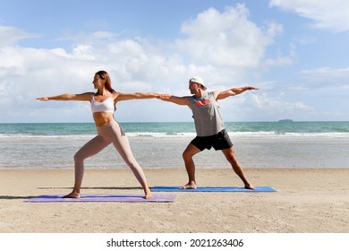 Buddy Athlete Woman, Man Doing Yoga And Stretching Body On Summer Island Beach, Couple Practicing Yoga At Seashore Of Tropical Ocean Blue Sea, Sport People Doing Exercise And Training Workout Outdoor