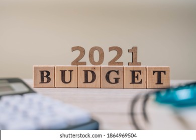 Budget 2021 Concept. 2021 Budget Wooden Cubes, Calculator And A Pen On Wooden Office Table.