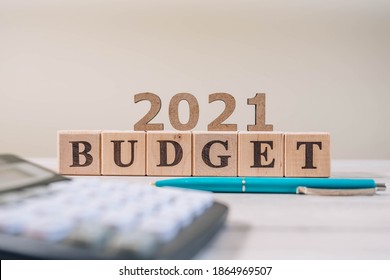 Budget 2021 Concept. 2021 Budget Wooden Cubes, Calculator And A Pen On Wooden Office Table.