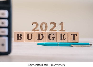 Budget 2021 Concept. 2021 Budget Wooden Cubes, Calculator And A Pen On Wooden Office Table.