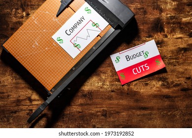 Budget Cut Concept Photo With Generic Budget Report On A Cutting Board