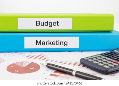 Budget And Marketing Words On Labels With Document Binders, Graphs And Business Reports