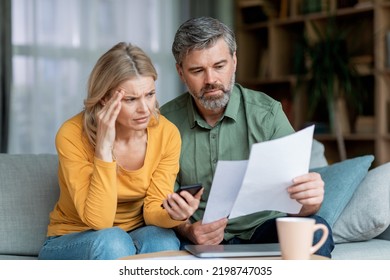 Budget Planning. Stressed Middle Aged Spouses Holding Papers And Calculating Family Spends Together, Thoughtful Mature Spouses Checking Documents, Suffering Financial Crisis, Closeup Shot - Powered by Shutterstock