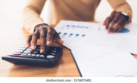 Budget Planning. Unrecognizable Black Businessman Using Calculator, Tracking Income And Expenses. Panorama, Copy Space