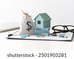 Budget real estate concept. Family budget planning. Investments, plans, savings. Mortgage and mortgage rates. Forecasts. Loan. Refinance home. Money bag and miniature house.