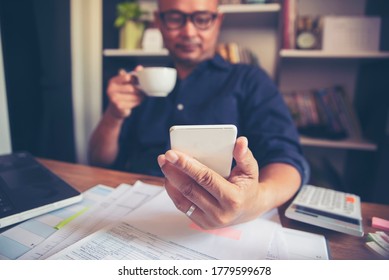 Budget and Tax planning concept, Accountant is calculating company annual tax and using mobile phone. Calendar 2019 and personal income tax form for who have income under US law placed on home desk