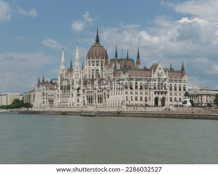 budpest capital houses of parliament red roof big building architecture donau river dome pillar water sky stone