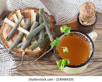 Buds, bark, aspen leaves, herbal tea, tincture, tea filter bags on a wooden table, flat layout. Medicinal plant populus tremula with salicin for use in alternative medicine, homeopathy and cosmetology