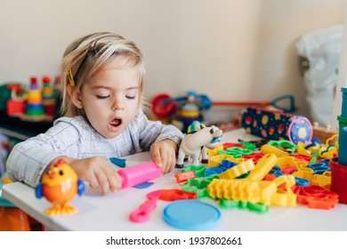 Budva, Montenegro - 17 march 2021: Child girl plays plasticine at the table in kindergarten.