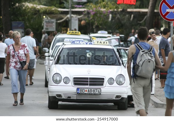 Budva, MONTENEGRO - 22 July 2011:white taxis\
waiting for passengers. Budva among the oldest urban settlements of\
the Adriatic coast.