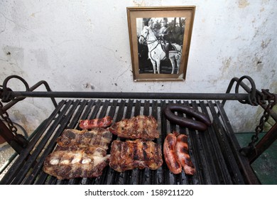 Buenos Aires, Buenos Aires / Argentina - 12-15-2019 : A Grill With Traditional Argentine Roast Next To A Photo Of Former President Juan Domingo Peron.