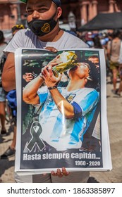 Buenos Aires, Argentina - 26 November, 2020: Photos, drawings, posters with a portrait of Diego Maradona in the hands of fans on the day of farewell to the idol