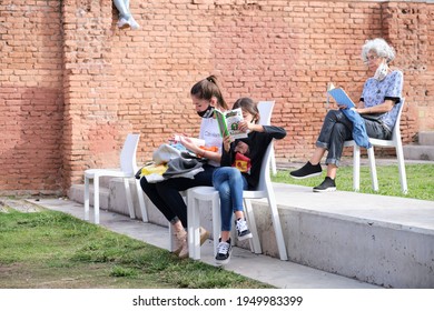 Buenos Aires, Argentina; April 2, 2021: Women Of Different Ages At A Reading Activity Keeping Distance For The Prevention Of Covid, During The Felba, Publishers And Bookstores Fair